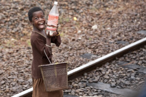 カメルーン、ンガウンデレのナンガ・エボゴ駅で明るく笑顔を見せる子供